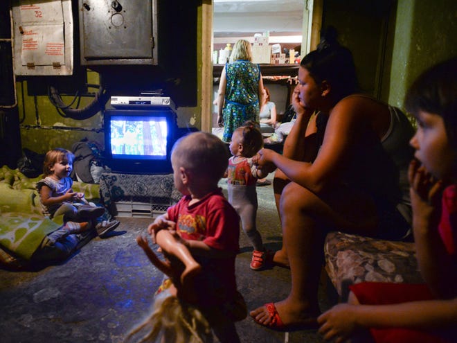 Families with children hide in the bomb shelter Monday in Petrovskiy district in Donetsk, eastern Ukraine. The Petrovskiy district of Donetsk is currently a frontline and one of the districts which has suffered the most from the artillery fights between Ukrainian army and Pro-Pussian rebels.