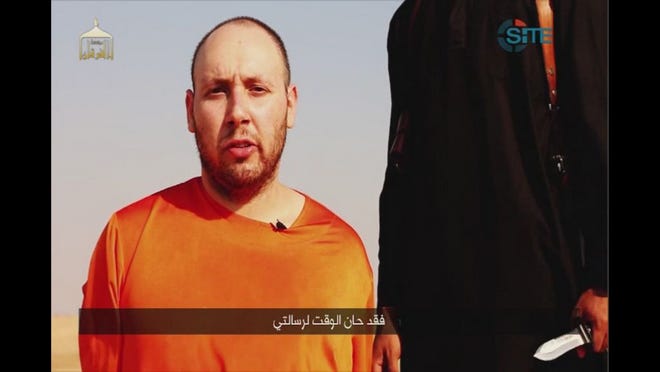 This image made from video posted on the Internet by Islamic State militants and provided by the SITE Intelligence Group, a U.S. terrorism watchdog, on Tuesday, Sept. 2, 2014, purports to show journalist Steven Sotloff before he was beheaded. Sotloff had last been seen in Syria in August 2013 until he appeared in a video released online by the Islamic State group on Aug. 19, 2014, that showed the beheading of fellow American journalist James Foley. The Arabic text at the bottom of the frame translates to "Now is the time for my message." (AP Photo)