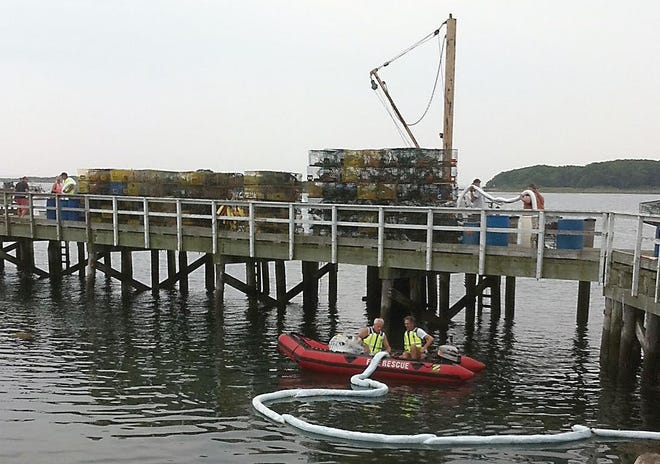 Photo courtesy of the Kennebunkport Fire Department
Kennebunkport firefighters begin the deployment of oil spill containment booms after responding to a reported oil spill off the coast of Cape Porpoise Sunday evening.