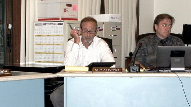 Rollingwood Councilwoman Amy Pattillo (far left) discusses an issue with (left to right) city attorney Doug Young, city administrator Charles Winfield, and Mayor Barry Bone at the Aug. 26 City Council meeting.