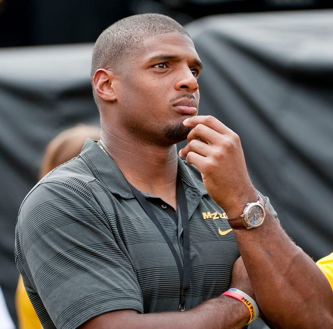 Former Missouri player Michael Sam watches pregame festivities before the start of the South Dakota State-Missouri NCAA college football game Saturday, Aug. 30, 2014, in Columbia, Mo. The St. Louis Rams cut Michael Sam, the first openly gay player drafted by an NFL team. Coach Jeff Fisher repeated over and over that it was purely a football decision.