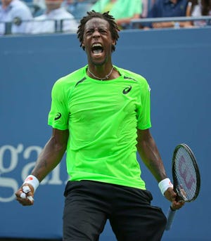 Gael Monfils, of France, reacts after a shot against Grigor Dimitrov, of Bulgaria, during the fourth round of the 2014 U.S. Open tennis tournament, Tuesday, Sept. 2, 2014, in New York. (AP Photo/Mike Groll)