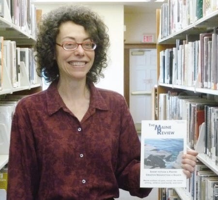 Katherine Mayfield proudly shows off her first edition of “The Maine Review.”