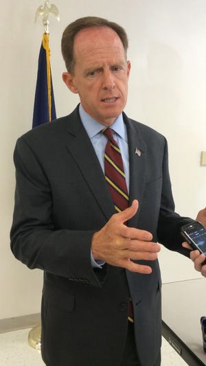 U.S. Sen. Pat Toomey, a Republican who represents Pennsylvania, speaks with reporters following a town hall meeting Tuesday morning in Waynesboro Ambulance Squad Building.