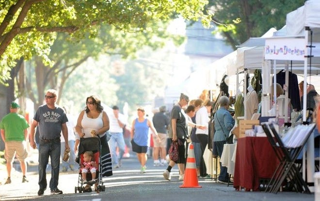 People walk down West Union Street checking out the vendors during last year's Wood Street Fair in Burlington City.