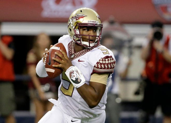 Florida State quarterback Jameis Winston rolls out of the pocket in the first half of an NCAA college football game against Oklahoma State, Saturday, Aug. 30, 2014, in Arlington, Texas.