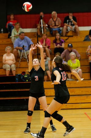 New Bern’s Jenna Seagle sets up Kayla Dellapia for a kill during Thursday’s volleyball match against South Central. New Bern won in four sets.