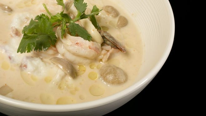 Tom kha soup with shrimp and grits epitomizes the East-meets-West theme at Kin & Comfort.
