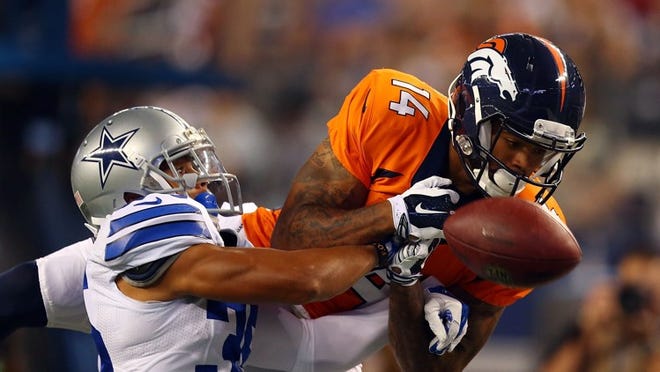 Cowboys cornerback Tyler Patmon, left, breaks up a pass intended for Cody Latimer of the Denver Broncos during an NFL preseason game on Aug. 28, 2014. CREDIT: Ronald Martinez/Getty Images
