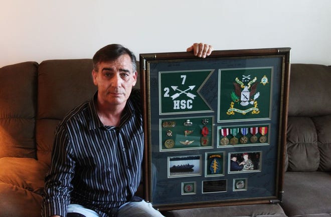 Monmouth resident Dale Leary sits next to the many awards he amassed over his lengthy career in the Army. Over the length of his 23-year career, he was awarded many honors, including a medal from one of the joint chiefs of staff. MATTHEW DUTTON/REVIEW ATLAS