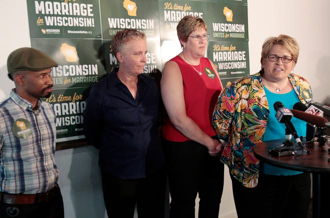 From left, Keith Borden, Salud Garcia, Katy Heyning and Judi Trampf, all plaintiffs in Wolf v. Walker, speak at a news conference Thursday in Madison, Wis. Earlier in the day, the 7th Circuit Court of Appeals in Chicago struck down the gay marriage bans of Wisconsin and Indiana as unconstitutional.
