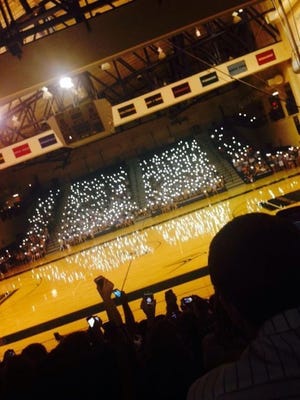 Students at Council Rock South light up the gym with their cell phones Tuesday night during a vigil in memory of the three boys who died in last weekend's car crash.