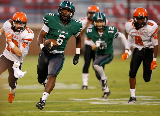 Norman North's Quan Hogan runs for the end zone after catching a pass during a high school football game between Norman North and Norman at Gaylord Family-Oklahoma Memorial Stadium in Norman, Okla., on Thursday, Sept. 4, 2014. Photo by Bryan Terry, The Oklahoman