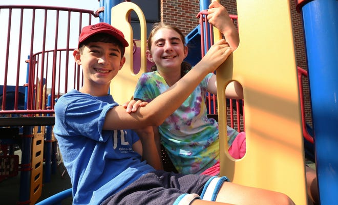 Marc Luban and Ariana Handelman, both 12, pose on the playground of Anshe Emet Synagogue in Chicago on Aug. 18. The duo has opted to build a playground in the Bronzeville neighborhood instead of having bar/bat mitzvah parties.