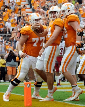 Tennessee quarterback Justin Worley, center, is congratulated by teammates after scoring a touchdown against Arkansas State during an NCAA college football game Saturday, Sept. 6, 2014, in Knoxville, Tenn. (AP Photo/Knoxville News Sentinel, Amy Smotherman Burgess)
