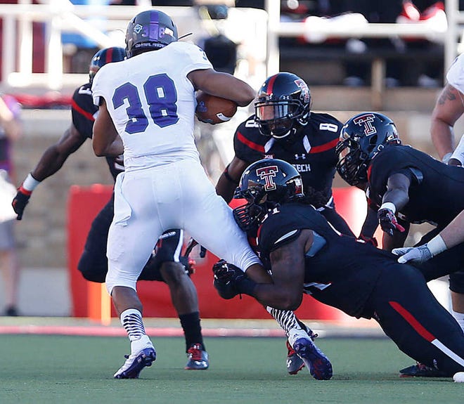 Central Arkansas' Blake Veasley is tackled by Texas Tech's Demetrius Alston during their game on Saturday in Lubbock. (Tori Eichberger/AJ Media)