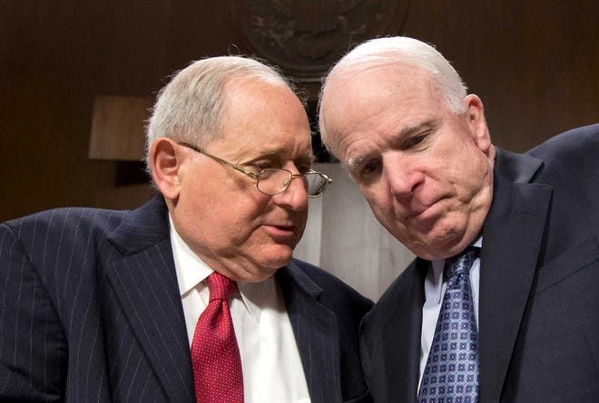 Sen. Carl Levin, D-Mich., left, talks with Sen. John McCain, R-Ariz., April 9, 2013, on Capitol Hill in Washington. After investigating the IRS for more than a year, the two senators disagree on whether the tax agency treated conservative groups worse than their liberal counterparts when they applied for tax-exempt status.