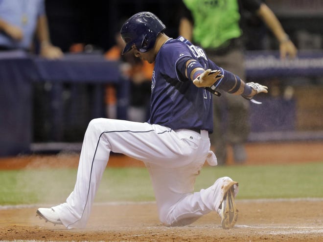Tampa Bay Rays' Yunel Escobar reacts after scoring the game-winning run on a passed ball by Baltimore Orioles catcher Nick Hundley during the ninth inning of a baseball game Saturday in St. Petersburg, Fla. The Rays won the game 3-2.