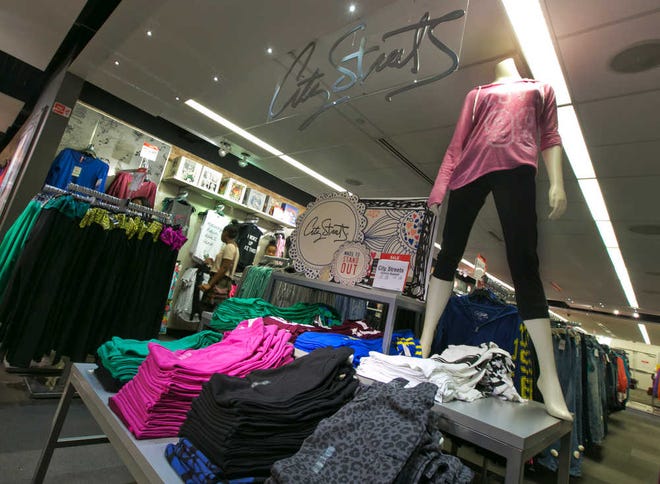 In this Tuesday, Aug. 19, 2014 photo, City Streets athleisure wear is displayed in the Juniors department at a J.C. Penney store, in New York. Sales of jeans in the U.S. fell 6 percent to $16 billion during the year that ended in June, according to research firm NPD Group, while sales of yoga pants and other "active wear" climbed 7 percent to $33.6 billion. (AP Photo/Richard Drew)