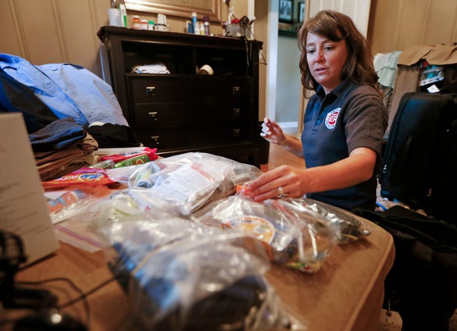 Rendi Murphree, an epidemiologist with the Centers for Disease Control and Prevention who will soon be leaving for Monrovia, Liberia, packs for her trip Friday at her home in Nashville, Tenn. AP Photo/ Mark Humphrey
