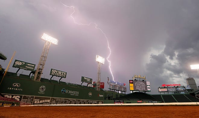 Lightning strikes over Fenway Park Saturday night as part of a storm that delayed the start of the Red Sox-Blue Jays game.