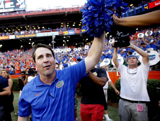 Florida Gators head coach Will Muschamp high-fives fans after the game against the Eastern Michigan Eagles at Ben Hill Griffin Stadium on Saturday, Sept. 6, 2014 in Gainesville, Fla. Florida defeated Eastern Michigan 65-0. (Matt Stamey/Staff photographer)