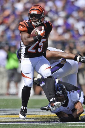Cincinnati Bengals running back Giovani Bernard (25) carries the ball during the first half of an NFL football game against the Baltimore Ravens in Baltimore, Md., Sunday. (AP Photo/Nick Wass)