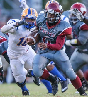 Gary McCullough For The Times-Union Raines' Alex Rutledge runs the ball while being pursued by Miami Northwestern's Patrick Banks during the first half Saturday.