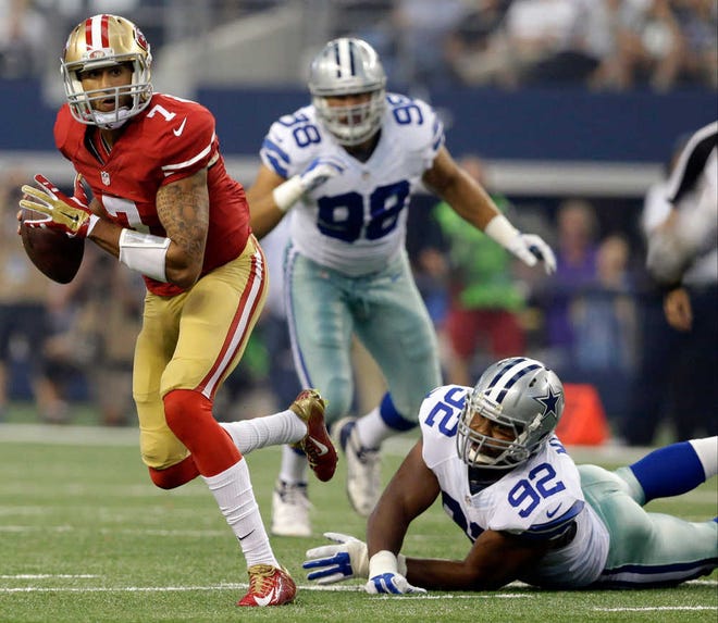 San Francisco 49ers quarterback Colin Kaepernick (7) escapes the grasp of Dallas Cowboys defensive end Jeremy Mincey (92) in the first half of an NFL football game, Sunday, Sept. 7, 2014, in Arlington, Texas. (AP Photo/LM Otero)