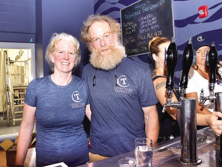 Galen and Tod Mott, owners of the Tributary Brewing Co. in Kittery, Maine, welcome customers during opening day of the tasting room on Saturday in Post Office Square on Shapleigh Road.