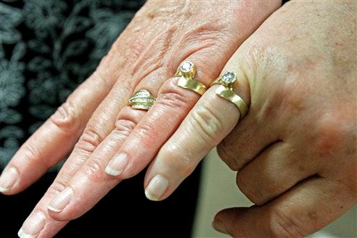 Kathy Chambery, left, and her partner, Marilyn Haring of 23 years, show off their rings after they were married at Magistrate Court in Santa Fe, N.M.