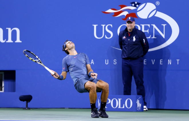 Tom Flint serves as a line judge at the U.S. Open as Rafael Nadal of Spain celebrates a match point.