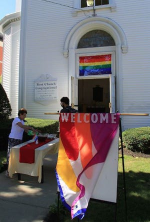 A welcome banner flies outside the First Congregational Church refreshments begin to be served.