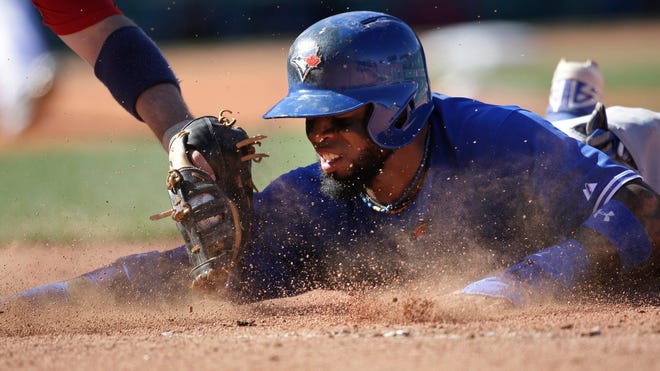 Toronto Blue Jays’ Jose Reyes is picked off first base as Boston Red Sox’s Allen Craig makes the tag during Sunday’s game in Boston.