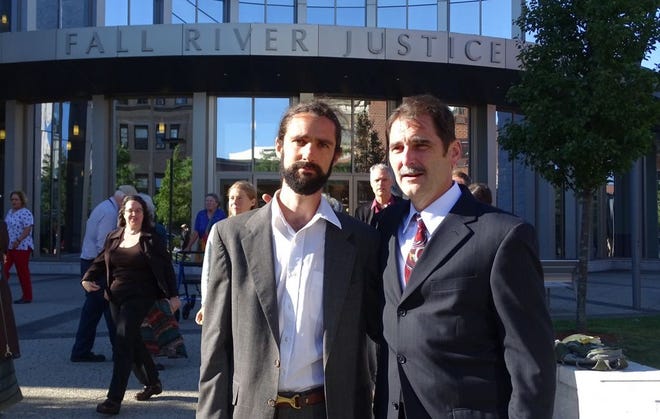 Jonathan O’Hara, left, and Ken Ward stand outside the Fall River Justice Center on Monday. Charges were dropped against the two for blocking a coal shipment to Brayton Point in 2013.