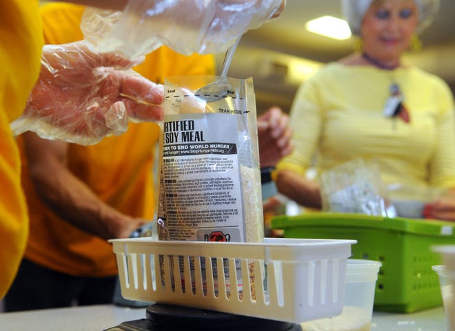 A rice meal is weighed during STOP Hunger Now, where over 150 volunteers from local Lutheran congregations packaged food at St. Andrew's Lutheran Church, Perkasie, Sunday, after raising $7,500 for STOP Hunger Now. (Catherine Meredith/Staff Photographer)