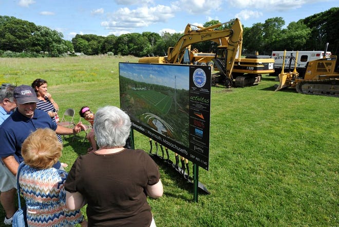 Residents look at a rendering of the renovated Legion Field during groundbreaking of the reconstruction project, July 6, 2014.