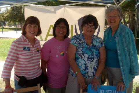 From left, Cindy Milford, Van Ha To-Cowell, Pat Davis,and Peggy Guttieri pause from describing to festivalgoers how AAUW offersthree $1,000 scholarships each year to San Joaquin Delta College graduates who go on to four-year colleges or universities.  (Not pictured is Guttieri's granddaughterDaphne Hannig.)
