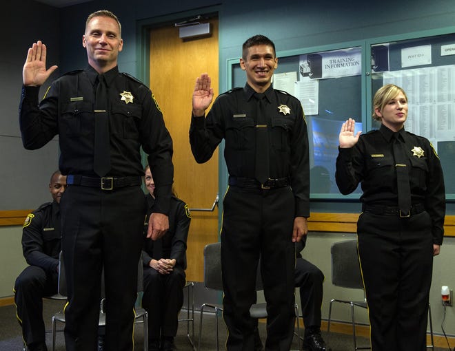 Three new deputies, standing, and three new correctional officers were sworn in Monday at the San Joaquin Sheriff's office in French Camp. CRAIG SANDERS/THE RECORD