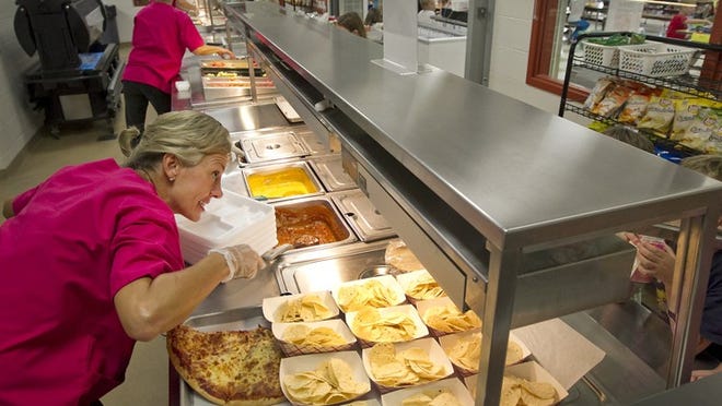At Rooster Springs elementary school in the Dripping Springs school district the students are offered a variety of healthy meatless options for lunch on Mondays as nutritionist Gail Williams serves from the line.
