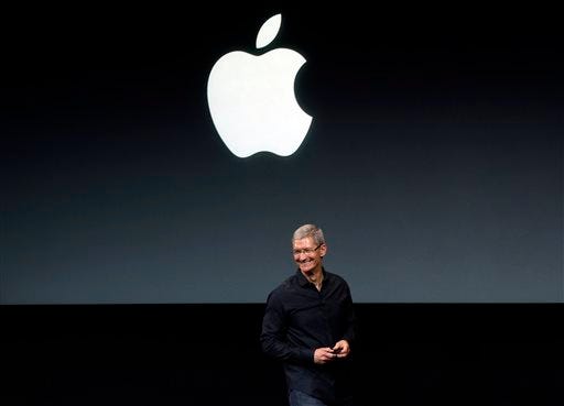 FILE - In this Tuesday, Sept. 10, 2013, file photo, Apple CEO Tim Cook speaks on stage before a new product introduction in Cupertino, Calif. Apple is poised to reveal its next big thing Tuesday, Sept. 9, 2014, in a crucial attempt to prove its technological tastemakers still have the power to mesmerize the masses.