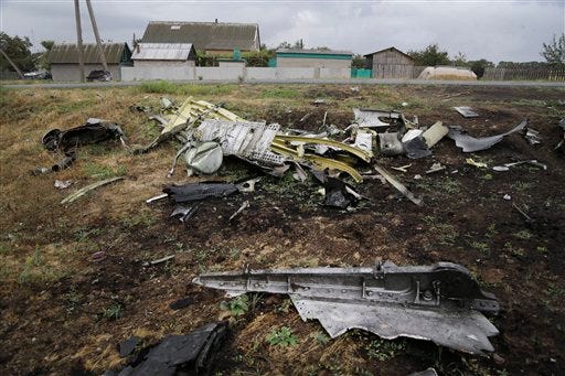 Pieces of the Malaysia Airlines Flight 17 plane are seen near village of Hrabove, eastern Ukraine, Tuesday, Sept. 9, 2014. The Dutch team investigating the downing of Malaysia Airlines Flight 17 over Eastern Ukraine says the crash was likely caused by the plane being hit by multiple "high-energy objects from outside the aircraft." The preliminary report published Tuesday by the Dutch Safety Board stopped short of saying the Boeing 777 was shot down by a surface-to-air missile, but its findings appear to point to that conclusion.