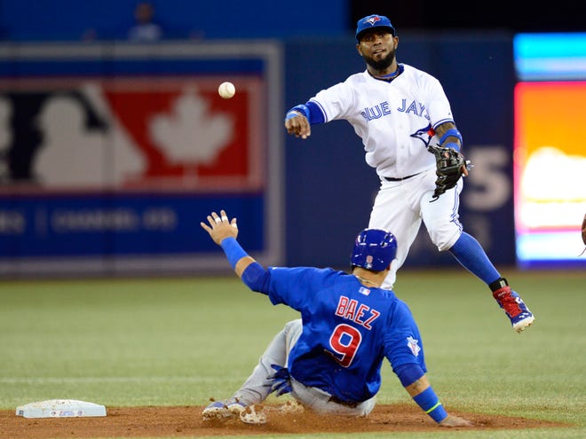 Blue Jays shortstop Jose Reyes avoids the slide of the Chicago Cubs’ Javier Baez to turn a double play Tuesday in the third inning of Toronto’s 9-2 win. (Frank Gunn/The Associated Press)