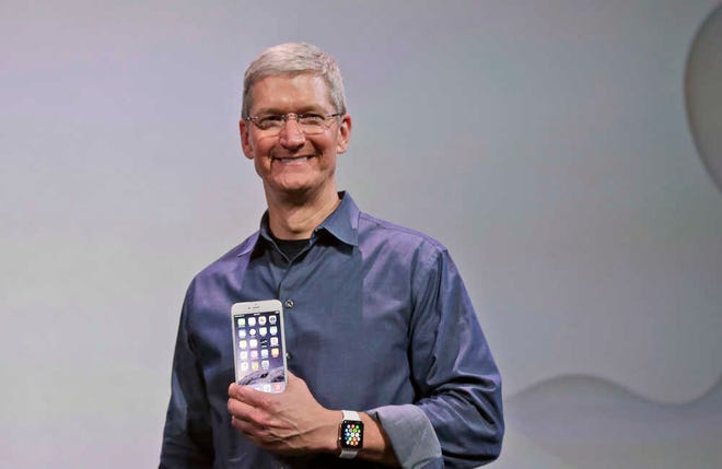 Apple CEO Tim Cook discusses the new Apple Watch and iPhone 6 on Tuesday, Sept. 9, 2014, in Cupertino, Calif. (AP Photo/Marcio Jose Sanchez)