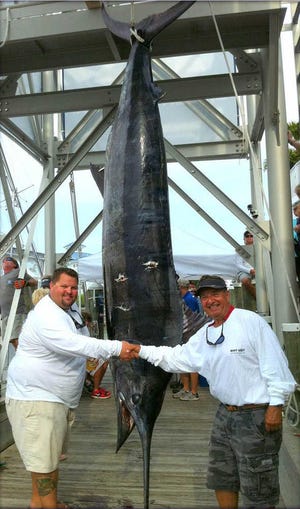 Captain Brent Morrison, left, and Captain Harry Cloud, both of St. Augustine, with a beautiful 847 pound blue marlin they caught off Ocean City, MD, in a billfish tournament Aug. 21. The fish set the all-time tourney record, eclipsing a 748-pounder caught in 1997. The pair fished with Captain Wade Lober on the Why Not.