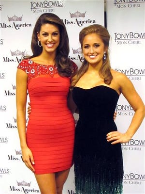 Miss Oklahoma Alex Eppler, left, who won the swimsuit competition, and Miss Kentucky Ramsey Carpenter, right, who won the talent competition with a fiddle performance, pose for a photo on the second night of preliminary competition at the Miss America pageant on Wednesday Sept. 10, 2014 in Atlantic City, N.J.