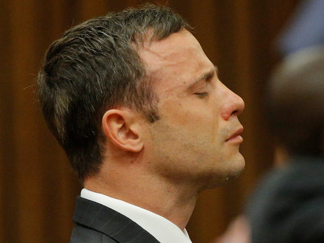Oscar Pistorius reacts in the dock in Pretoria, South Africa, Thursday as Judge Thokozile Masipa reads notes as she delivers her verdict in Pistorius' murder trial. The South African judge in Oscar Pistorius’ murder trial said Thursday that prosecutors have not proved beyond a reasonable doubt that the double-amputee Olympic athlete is guilty of premeditated murder.