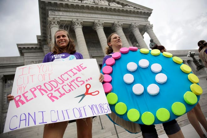 Abortion-rights supporters Dina van der Zalm, right, and Allyson Junker stand on the steps of the Missouri Capitol Wednesday, Sept. 10, 2014, in Jefferson City, Mo. Missouri lawmakers are expected to consider whether to override a veto by Gov. Jay Nixon of legislation requiring a 72-hour waiting period for abortions, one of the longest mandatory delays in the nation, during a special legislative session that begins Wednesday. (AP Photo/Jeff Roberson)