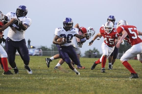 The Cavaliers take on the Cardinals during football action Friday.