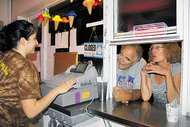 Nicole Pagano serves ice cream to Milford Borough residents Joyce Trentacosta, who had coconut ice cream with chocolate dip, and Ethan Turner, whose choice was vanilla and chocolate swirls with chocolate sprinkles.